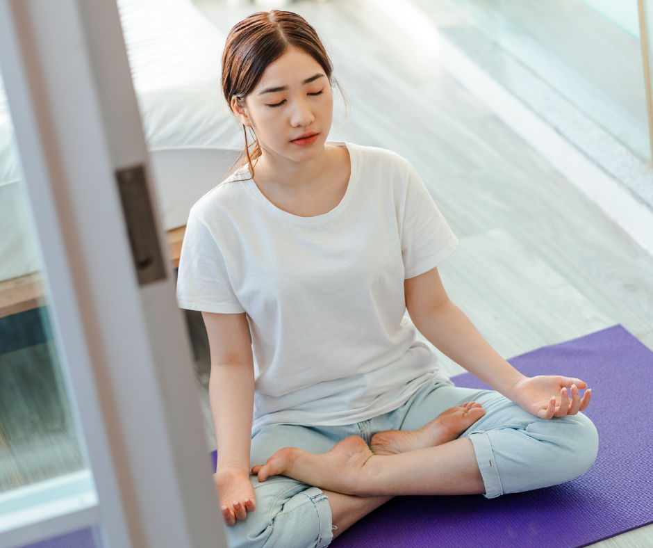 Young woman meditating in yoga therapy session
